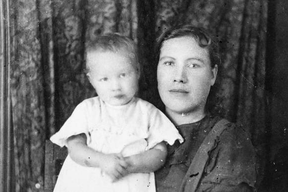 Schwarzweissfoto einer Frau mit einem Kleinkind auf dem Arm 